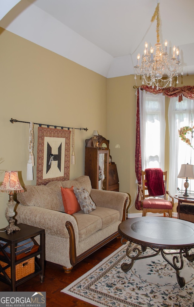 living area with a chandelier, wood finished floors, and lofted ceiling