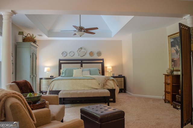 bedroom with ceiling fan, light colored carpet, a raised ceiling, baseboards, and ornate columns
