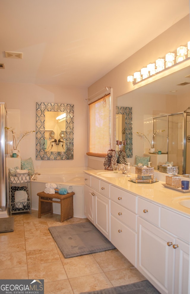 bathroom featuring double vanity, a garden tub, tile patterned flooring, a shower stall, and a sink