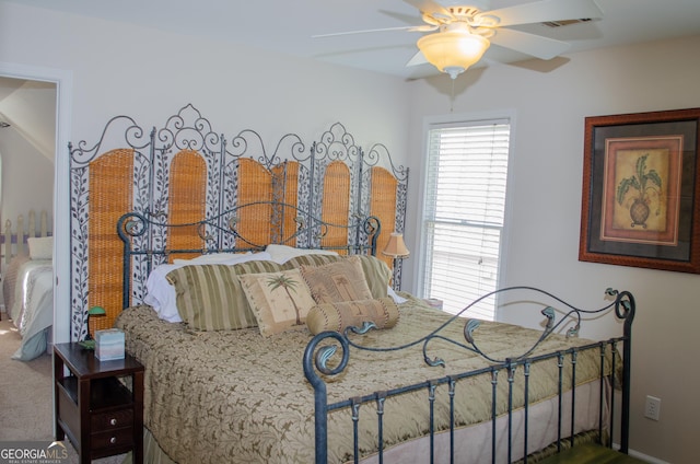 bedroom featuring carpet flooring, a ceiling fan, baseboards, and visible vents