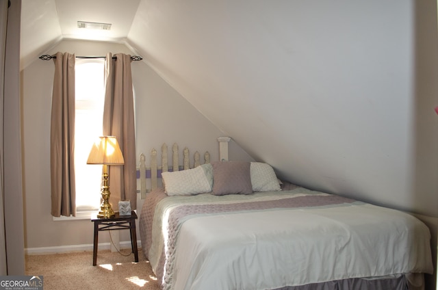 carpeted bedroom with visible vents, baseboards, and lofted ceiling