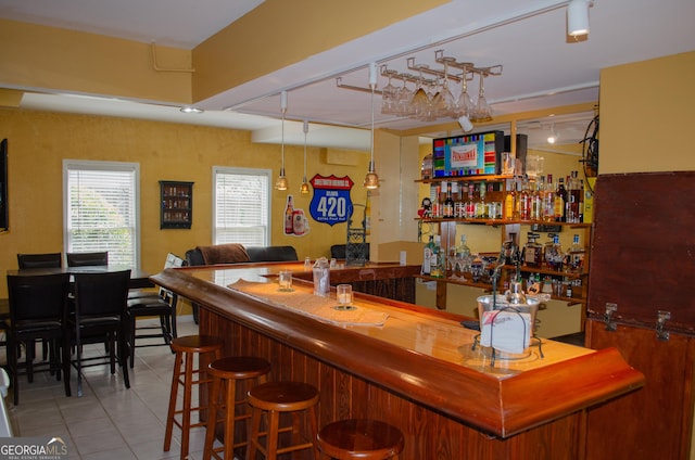 bar featuring wet bar and tile patterned floors