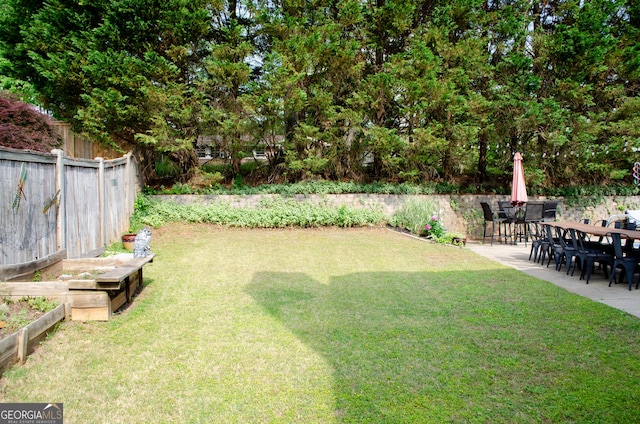 view of yard with a patio, a garden, and fence