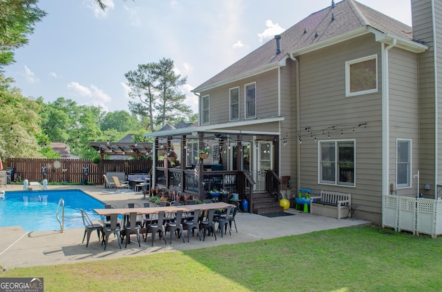 rear view of property with fence, a fenced in pool, a pergola, and a patio area