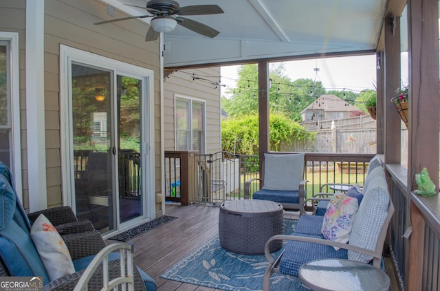 sunroom / solarium featuring plenty of natural light and ceiling fan