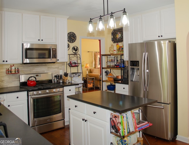kitchen with white cabinetry, tasteful backsplash, dark countertops, and stainless steel appliances