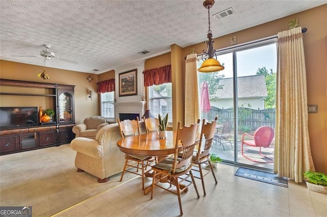 238 Diamond Valley Pass, Canton, GA 30114 - dining room featuring visible vents, a textured ceiling, and a fireplace