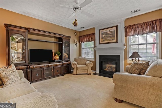 238 Diamond Valley Pass, Canton, GA 30114 - living room with light carpet, a textured ceiling, a ceiling fan, a fireplace with flush hearth, and visible vents