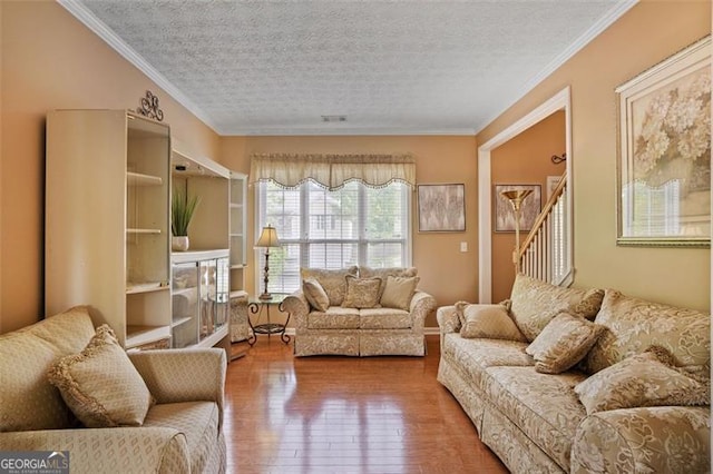 238 Diamond Valley Pass, Canton, GA 30114 - living room with wood-type flooring, a textured ceiling, ornamental molding, and stairway