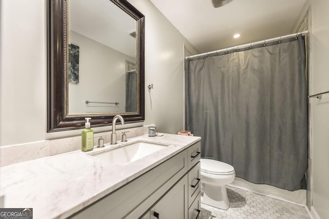 bathroom featuring a shower with curtain, tile patterned floors, vanity, and toilet
