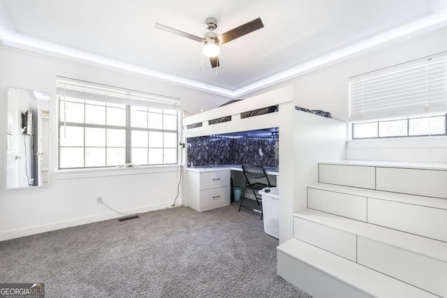unfurnished bedroom featuring ceiling fan, visible vents, and carpet