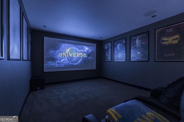 home theater room featuring baseboards and carpet