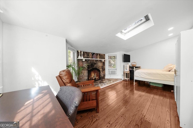45 Michelle Cir NE, Atlanta, GA 30342 - bedroom featuring wood-type flooring, lofted ceiling, a skylight, and a fireplace