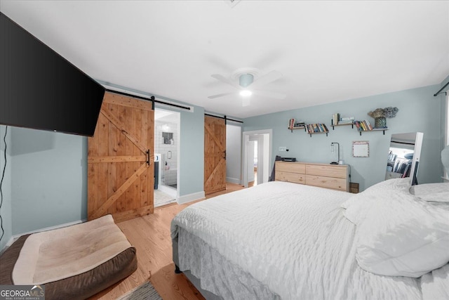 45 Michelle Cir NE, Atlanta, GA 30342 - bedroom featuring a barn door, light wood-type flooring, and ceiling fan