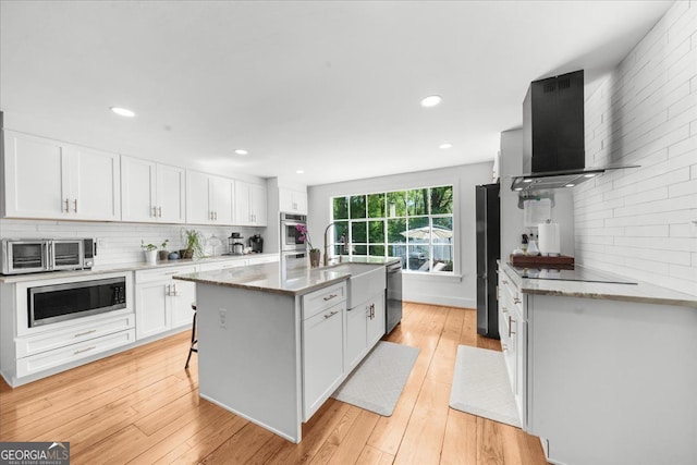 45 Michelle Cir NE, Atlanta, GA 30342 - kitchen with exhaust hood, appliances with stainless steel finishes, a sink, tasteful backsplash, and recessed lighting