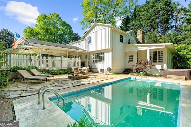 45 Michelle Cir NE, Atlanta, GA 30342 - back of house featuring a patio, an outdoor pool, a chimney, and board and batten siding