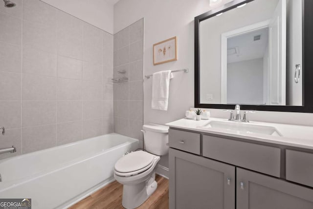 full bathroom featuring vanity, visible vents, wood finished floors, toilet, and shower / tub combination