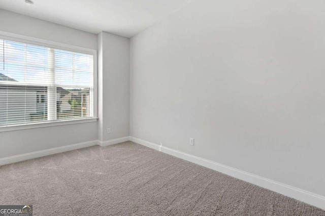 empty room with carpet flooring and baseboards
