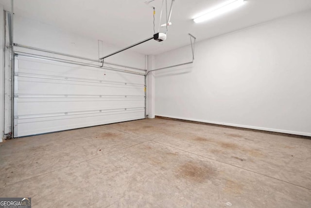 garage featuring baseboards and a garage door opener