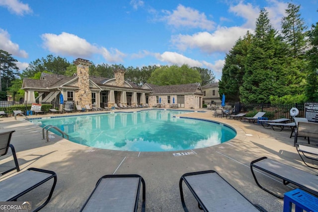 pool featuring a patio and fence