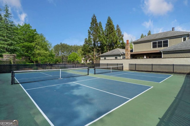 view of tennis court featuring fence and community basketball court