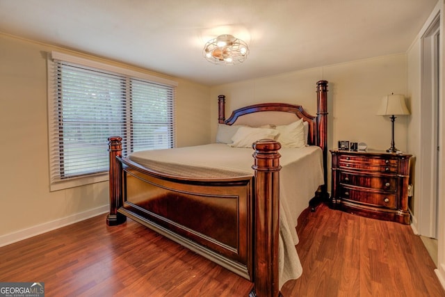 bedroom with baseboards and wood finished floors