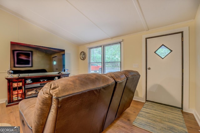 living area featuring baseboards, vaulted ceiling, and light wood-style flooring
