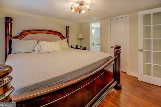 bedroom with wood finished floors and ensuite bathroom
