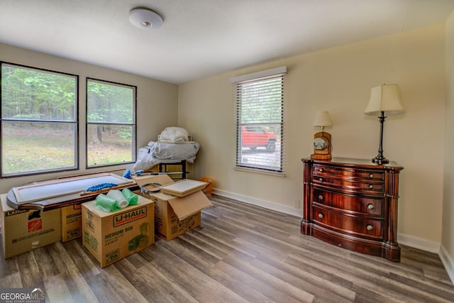 interior space featuring baseboards and wood finished floors