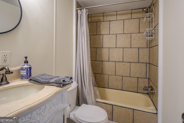 full bath featuring toilet, tiled shower / bath, and vanity