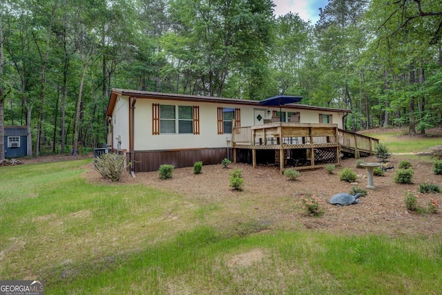 back of house featuring a deck