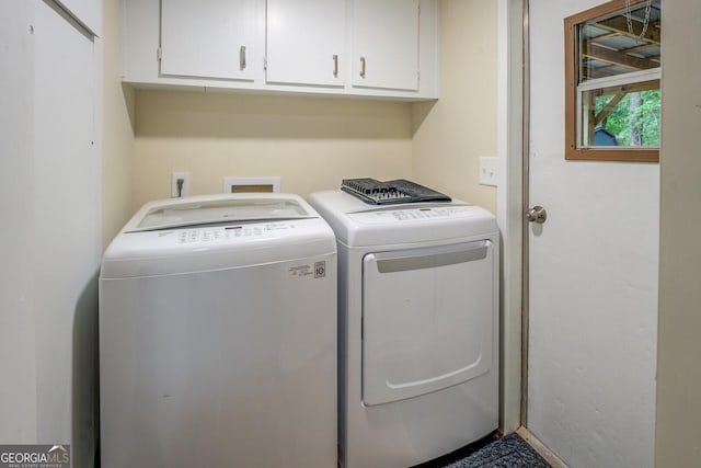 washroom featuring washer and clothes dryer and cabinet space