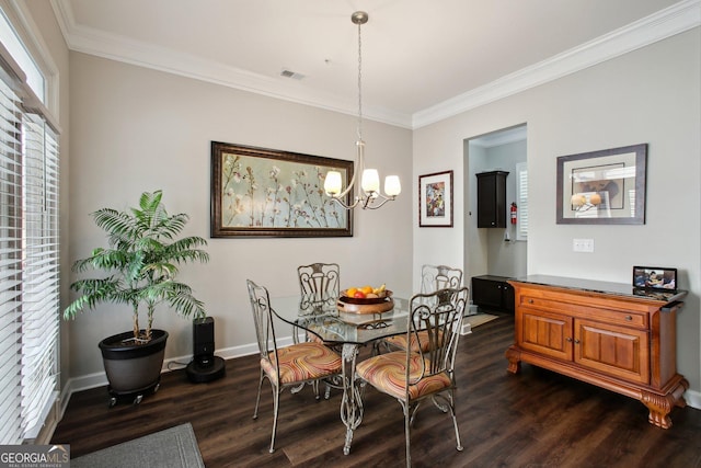dining area with dark wood-style flooring, visible vents, crown molding, baseboards, and a chandelier