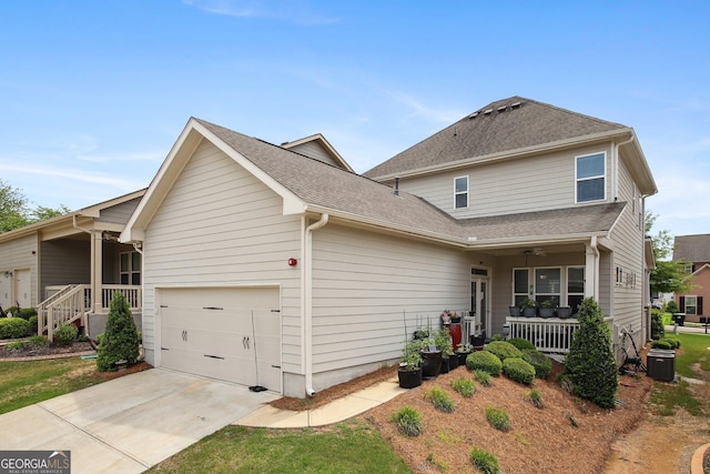 view of front facade featuring a porch, a garage, roof with shingles, and driveway
