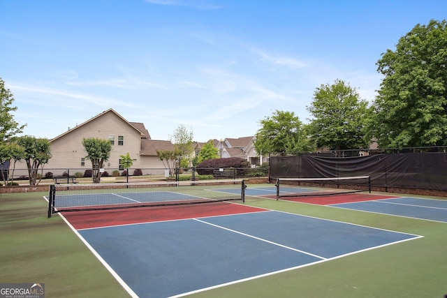 view of tennis court featuring fence and community basketball court