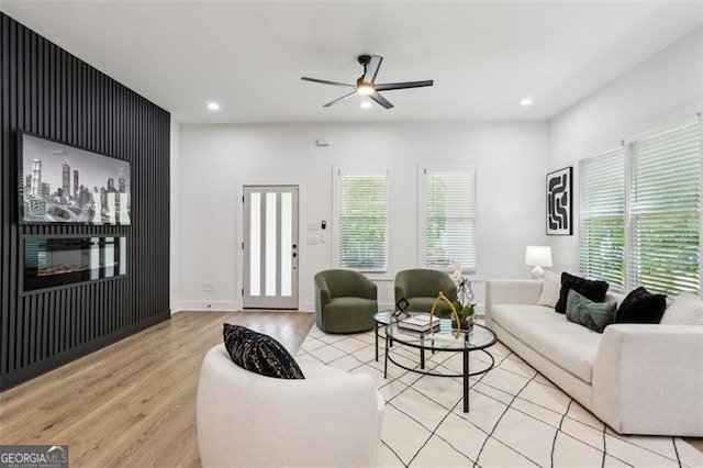 living area with recessed lighting, light wood-style flooring, ceiling fan, and a healthy amount of sunlight