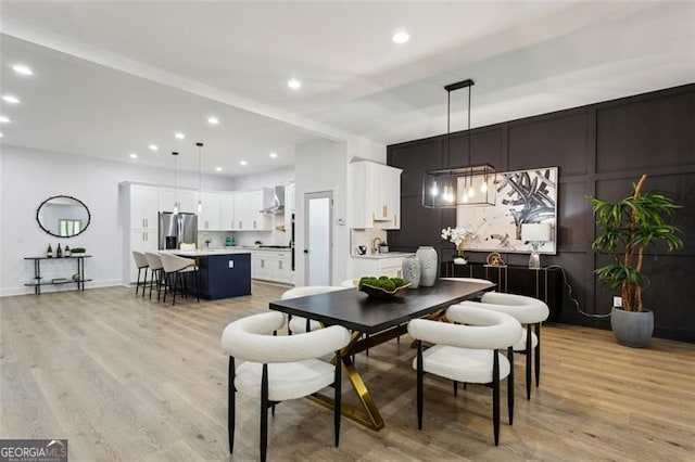 dining space featuring recessed lighting and light wood-type flooring