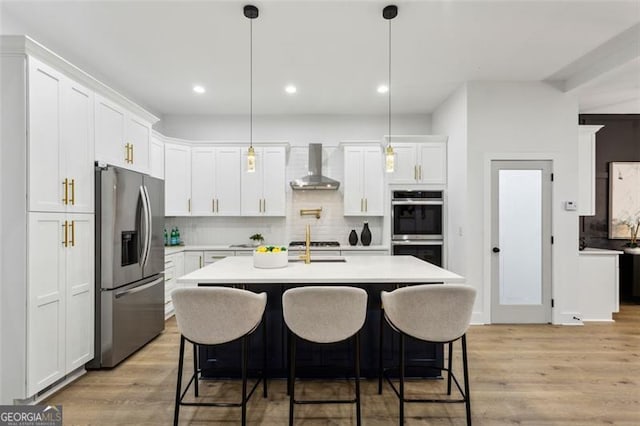 2438 2nd St, Atlanta, GA 30318 - kitchen with stainless steel appliances, wall chimney range hood, light countertops, decorative backsplash, and recessed lighting