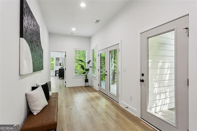 doorway to outside featuring visible vents, recessed lighting, baseboards, and light wood-type flooring