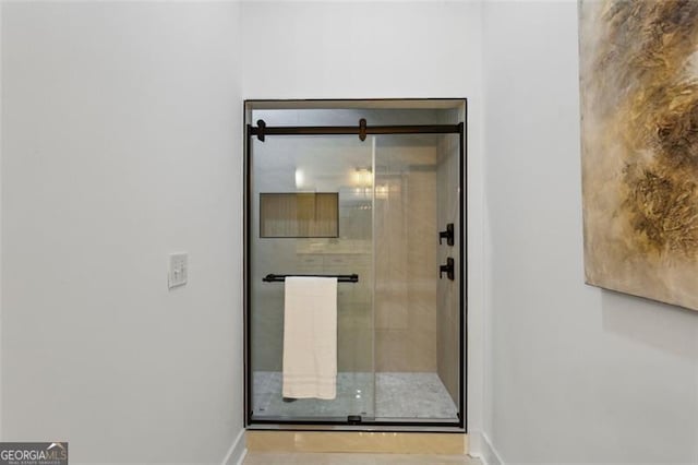 interior space with baseboards and a stall shower