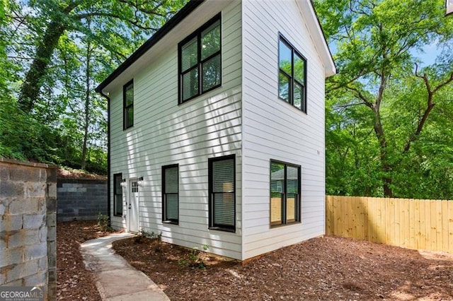 view of side of property with fence