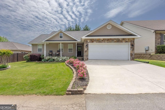 view of front of property with a front lawn, an attached garage, stone siding, a porch, and driveway