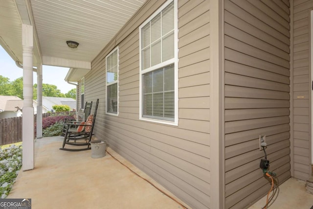view of patio / terrace with fence and covered porch