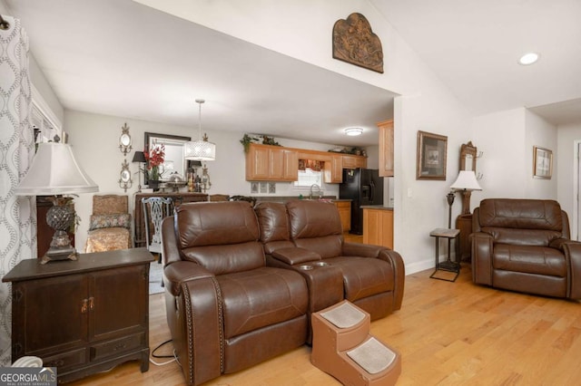 living area with light wood-type flooring, recessed lighting, baseboards, and vaulted ceiling