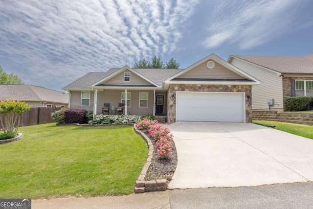 view of front of house featuring a front lawn, fence, stone siding, concrete driveway, and an attached garage