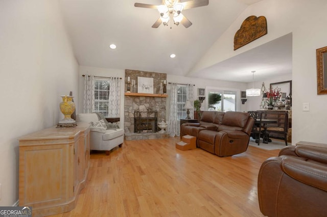 living room with a fireplace, recessed lighting, ceiling fan, and light wood-style floors