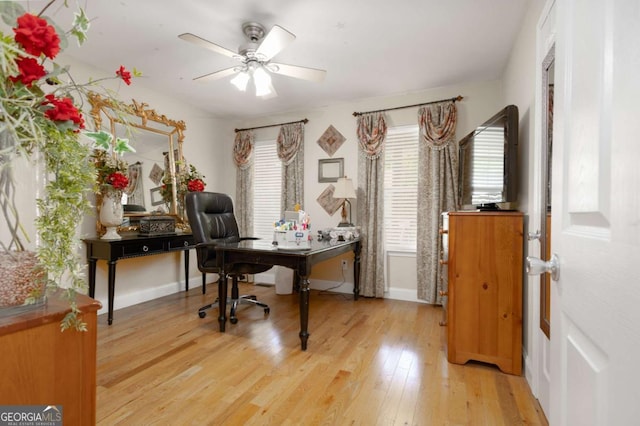office area featuring baseboards, ceiling fan, and light wood-type flooring
