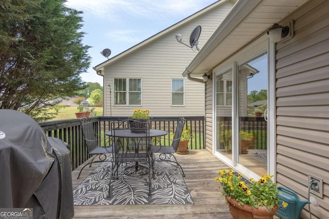 wooden terrace with outdoor dining area