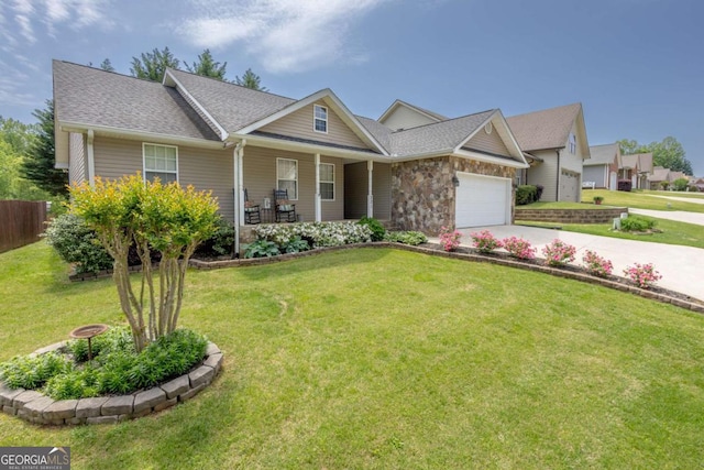 view of front of property with fence, an attached garage, a front yard, covered porch, and driveway