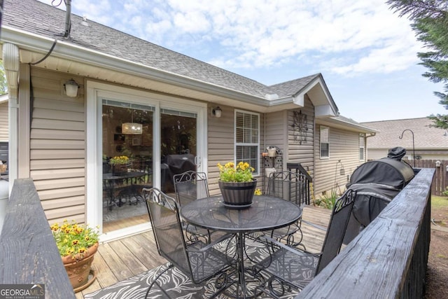 wooden terrace featuring outdoor dining space